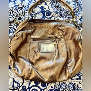 Coach purse - gold with hot pink liner